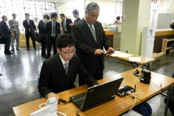 タブレット端末で情報配信システムを確認する伊藤色麻町長