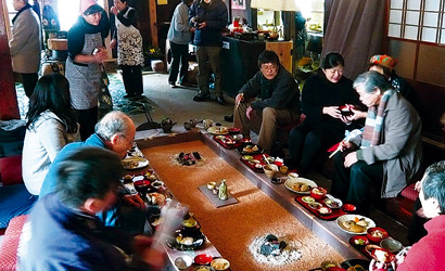 「うぶすなの家」で食事をとる人々の写真